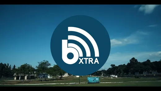 The open parkland where the pop-up is set up, with the bXTRA mark over it.